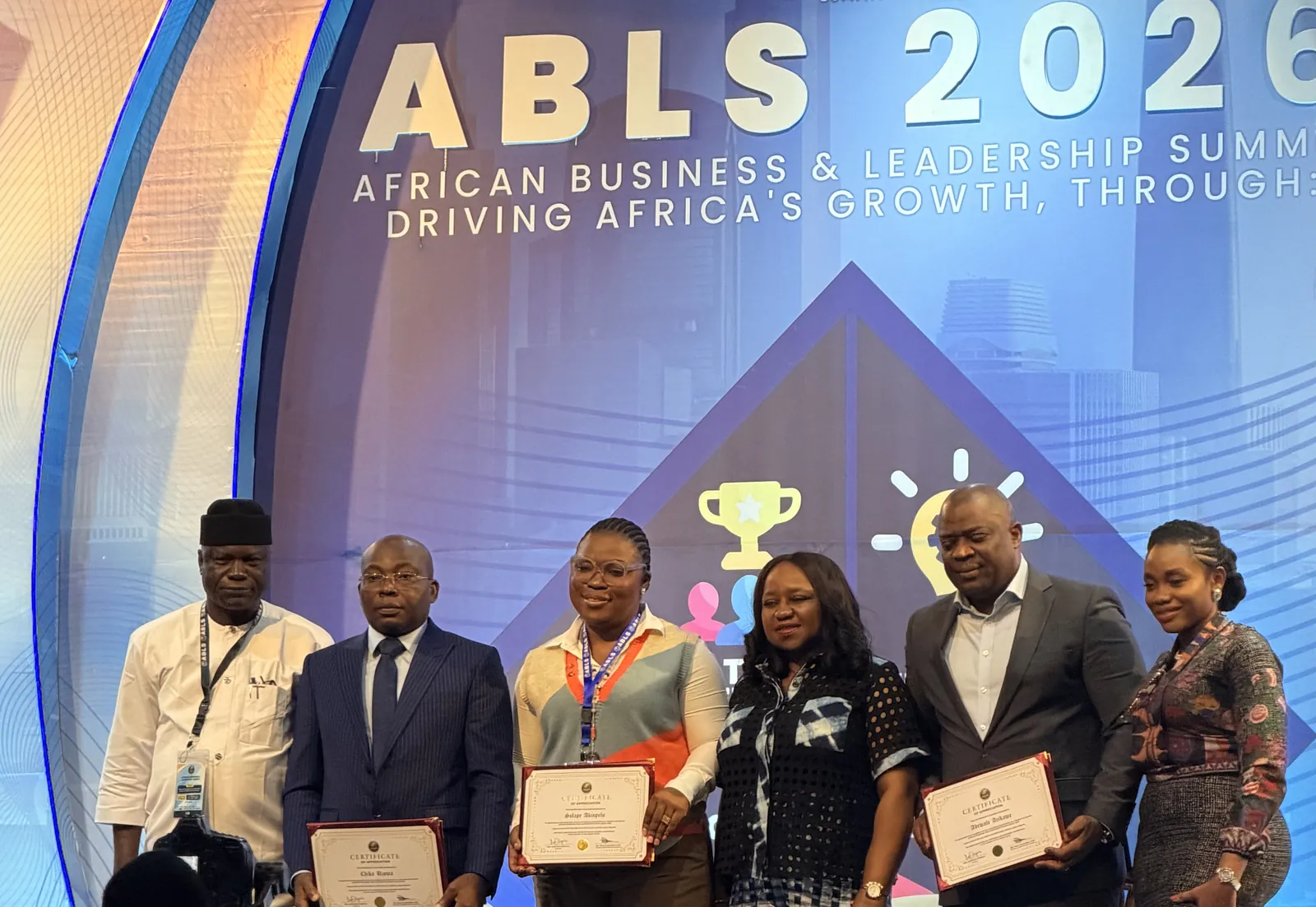 Guests holding certificates on stage at the African Business and Leadership Summit 2026