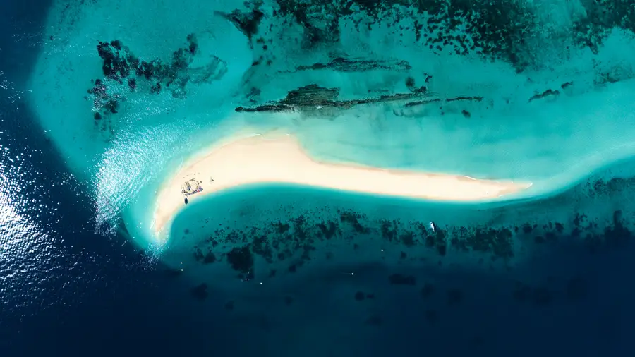 A sandbar surrounded by turquoise water in Zanzibar